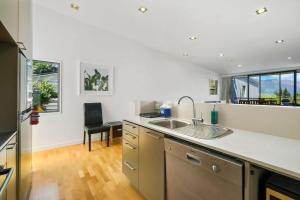 a kitchen with a sink and a counter top at The Alps Apartment in Queenstown