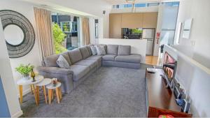 a living room with a couch and a table at The Alps Apartment in Queenstown