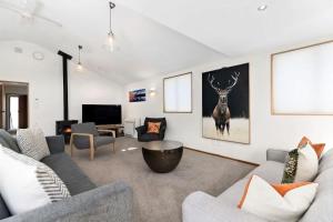 a living room with a couch and a table at Botanical Bliss in Arrowtown