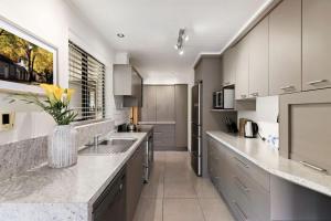 a kitchen with a sink and a counter top at Botanical Bliss in Arrowtown