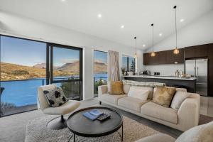 a living room with a couch and a table at Bluewater Views in Queenstown
