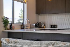 a kitchen with a sink and a counter top at Bluewater Views in Queenstown +22 photos