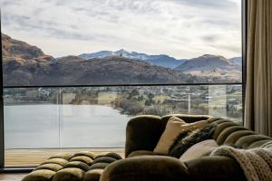 a couch in a living room with a large window at Northview Residence in Frankton