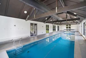 a large swimming pool with blue water at Glebe Arrowtown in Arrowtown