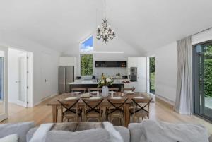 a dining room and living room with a table and chairs at Glebe Arrowtown in Arrowtown