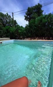 a person sitting in a swimming pool at Casa de Flia in Villa Gesell
