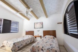 Postel nebo postele na pokoji v ubytování Mar y Cocos Hotel & Villas