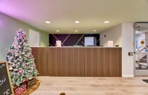 a christmas tree in a waiting area of a store at The West End in Tower Grove