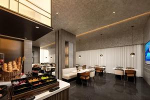 a restaurant with tables and chairs and a buffet at Atour Hotel Shanghai Songjiang G60 Dongjing in Shanghai