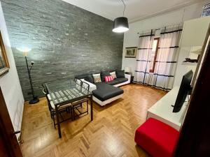 a living room with a couch and a table at Florence Lungarno Apartment in Florence