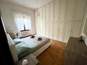 a bedroom with a bed and a window at Florence Lungarno Apartment in Florence