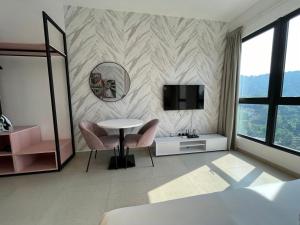 a living room with a table and chairs and a television at Paxtonz Premium Studio-IKEA,One Utama,Hextar World-Damansara KL in Petaling Jaya
