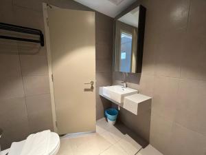 a bathroom with a toilet and a sink and a mirror at Paxtonz Premium Studio-IKEA,One Utama,Hextar World-Damansara KL in Petaling Jaya +18 photos