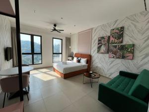 a bedroom with a bed and a couch in a room at Paxtonz Premium Studio-IKEA,One Utama,Hextar World-Damansara KL in Petaling Jaya