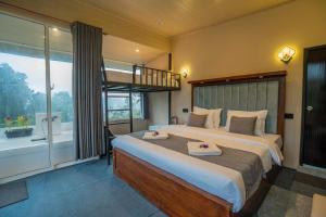 a bedroom with a large bed and a large window at Lavee Villa Ella in Ella