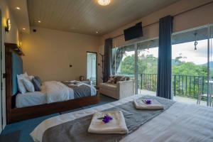 a bedroom with two beds and a balcony at Lavee Villa Ella in Ella +5 photos
