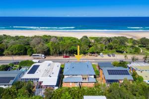 an aerial view of a beach with buildings and the ocean at Spades - at Lighthouse Beach in Port Macquarie