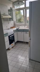 a kitchen with white appliances and a large window at RELAX Privacy in Sarcelles