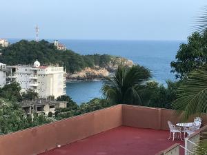 a balcony with a view of the ocean at Casa Penélope in Puerto Ángel
