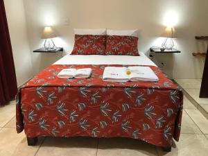 a bedroom with a bed with two towels on it at Casa Penélope in Puerto Ángel