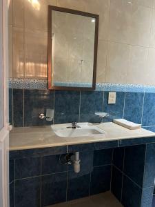a bathroom with a sink and a mirror at Casa Penélope in Puerto Ángel +37 photos