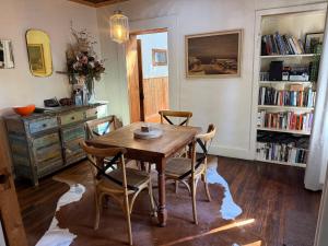 a dining room with a wooden table and chairs at Gladstone House in Beechworth