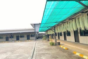 a building with a blue awning next to a parking lot at The Loft @Chiangrai in Ban Du +88 photos
