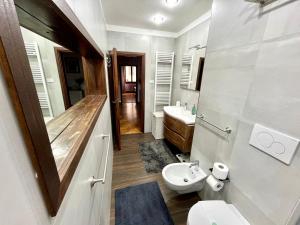 a bathroom with a toilet and a sink at Florence Lungarno Apartment in Florence +16 photos