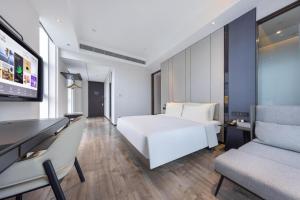 Postel nebo postele na pokoji v ubytování Atour X Hotel Shanghai Shuguang Wusong Cruise Terminal + 21 fotografií