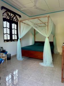 a bedroom with a bed with mosquito nets at Villa Sama Mandira in Ranna +23 photos