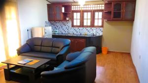 a living room with two chairs and a table at Nylander Co-operative Society in Mahabage