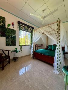 a bedroom with a bed with a canopy at Villa Sama Mandira in Ranna