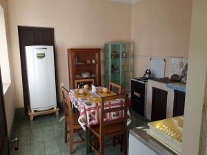 a kitchen with a table with chairs and a refrigerator at Departamento a 1 cuadra de la Plaza Principal in Sucre +10 photos