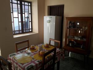 a kitchen with a table and a white refrigerator at Departamento a 1 cuadra de la Plaza Principal in Sucre