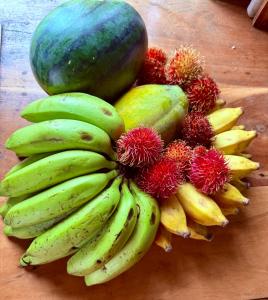 a bunch of bananas and other fruits on a table at Villa Sama Mandira in Ranna
