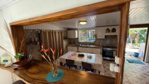 a kitchen with a table and a dining room at Ave Surfing House in Mahina