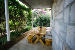 a wooden table sitting in the corner of a patio at Apartments Jozica in Brna - Insel Korcula 6371 in Brna