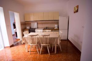 a kitchen with a table and chairs and a refrigerator at Apartments Jozica in Brna - Insel Korcula 6371 in Brna