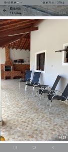 a group of chairs sitting in a room at Maitinga, a little paradise in Bertioga