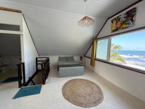 a living room with a view of the ocean at Ave Surfing House in Mahina