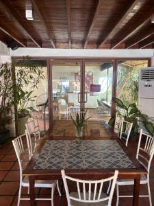 a wooden table and chairs on a patio at Jungle Hostel in Puerto Princesa City