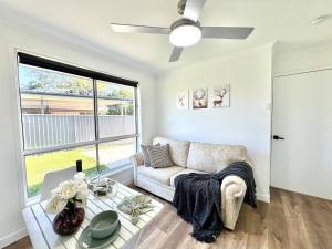 a living room with a couch and a table at Studio in Belmont | Easy to City & Airport in Brisbane