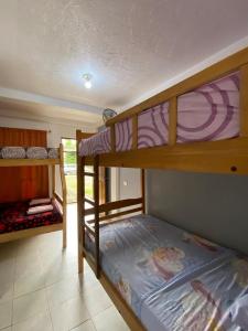 a bedroom with two bunk beds in a room at Tierra y Mar in Montañita