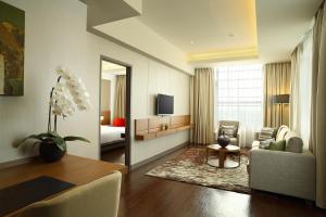 a living room with a couch and a table at Hotel Santika Premiere ICE - BSD City in Serpong