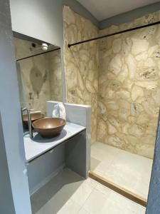 a bathroom with a wooden bowl on a sink at Nakawe Guatape in Guatapé
