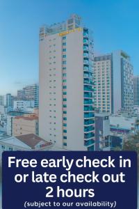 a city skyline with a tall white building at Gosia Hotel in Nha Trang