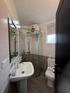 a bathroom with a sink and a toilet and a shower at Nomentano Blue -Luxury Apartments- in Nuwara Eliya +21 photos