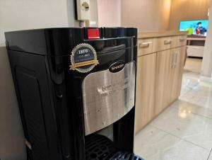 a large black refrigerator sitting in a kitchen at Stylish 3BR Skandinavia Tangcity Apt Max 12 Guests in Karawaci +36 photos