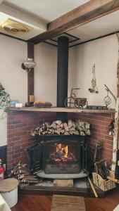 a brick fireplace with a fire in it at Twin Peaks Lodge in Hakuba