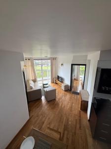 an aerial view of a living room with wooden floors at Nomentano Blue -Luxury Apartments- in Nuwara Eliya